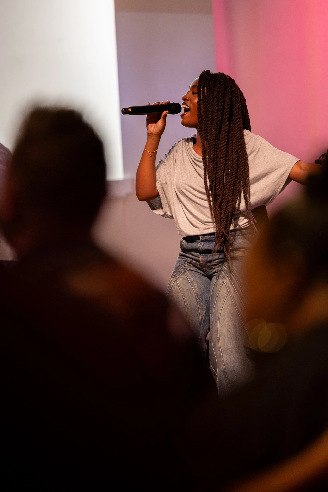 Vocalist performing to an audience during a live Houston event