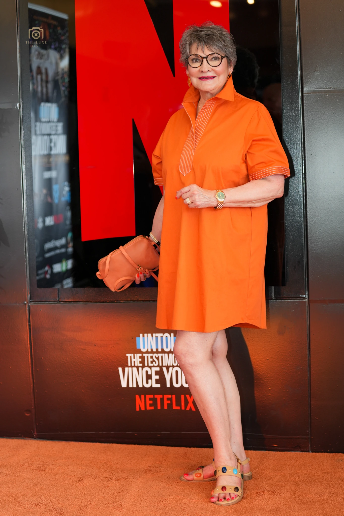 Guest wearing orange on the Vince Young Netflix Untold premiere carpet