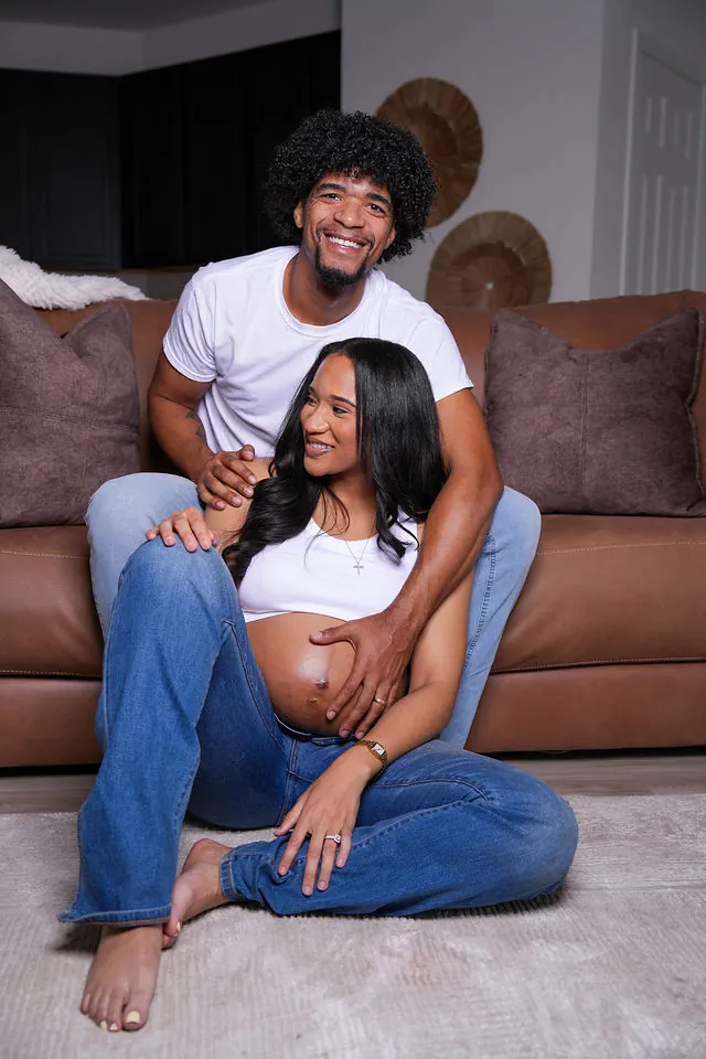 Expecting couple relaxing during an at-home maternity session