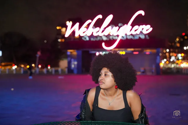 Night portrait beneath a Wedding Love neon sign